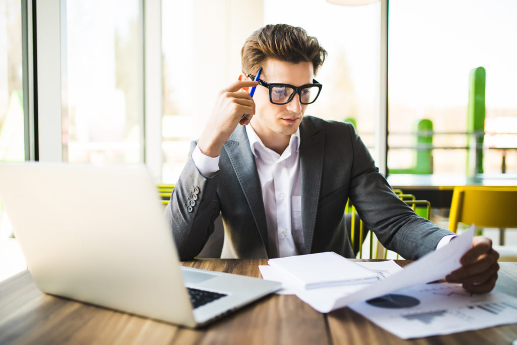 Young professional looking over reports intently