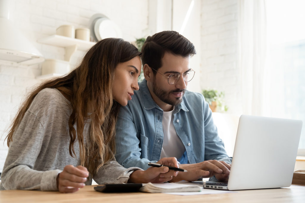 Couple working on bills at their kitchen table